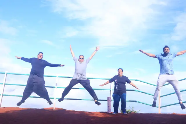 Students mid-jump on the rooftop at the end of a retreat morning.