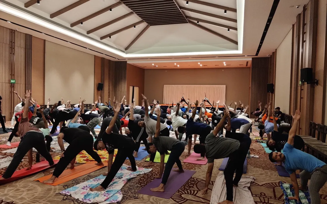 A conference hall of students in triangle pose at SIIHE, Goa.