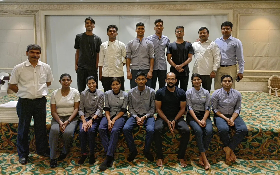 The hotel team seated with Abhilash for a group photograph after the World Health Day session at Taj Vivanta.