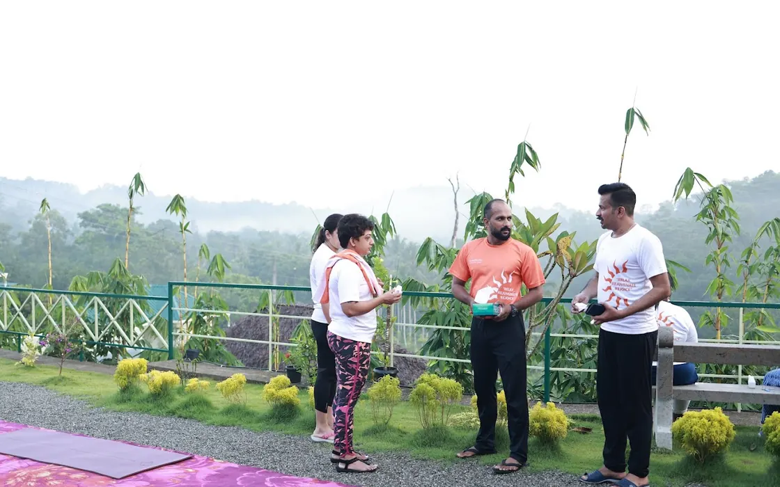 Retreat participants talking on the hilltop terrace before the morning class.